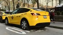 Gravity Tesla Model Y NYC yellow taxi rear three-quarter view