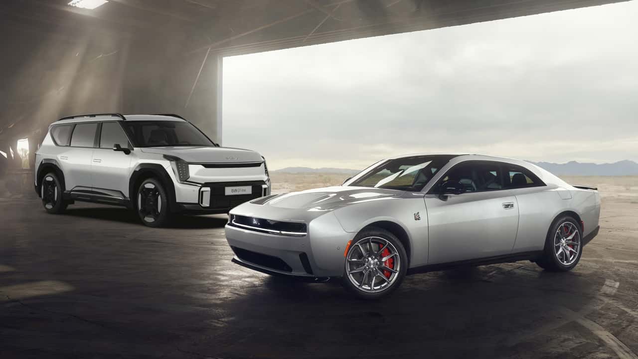 2024 dodge charger next to kia ev9 suv