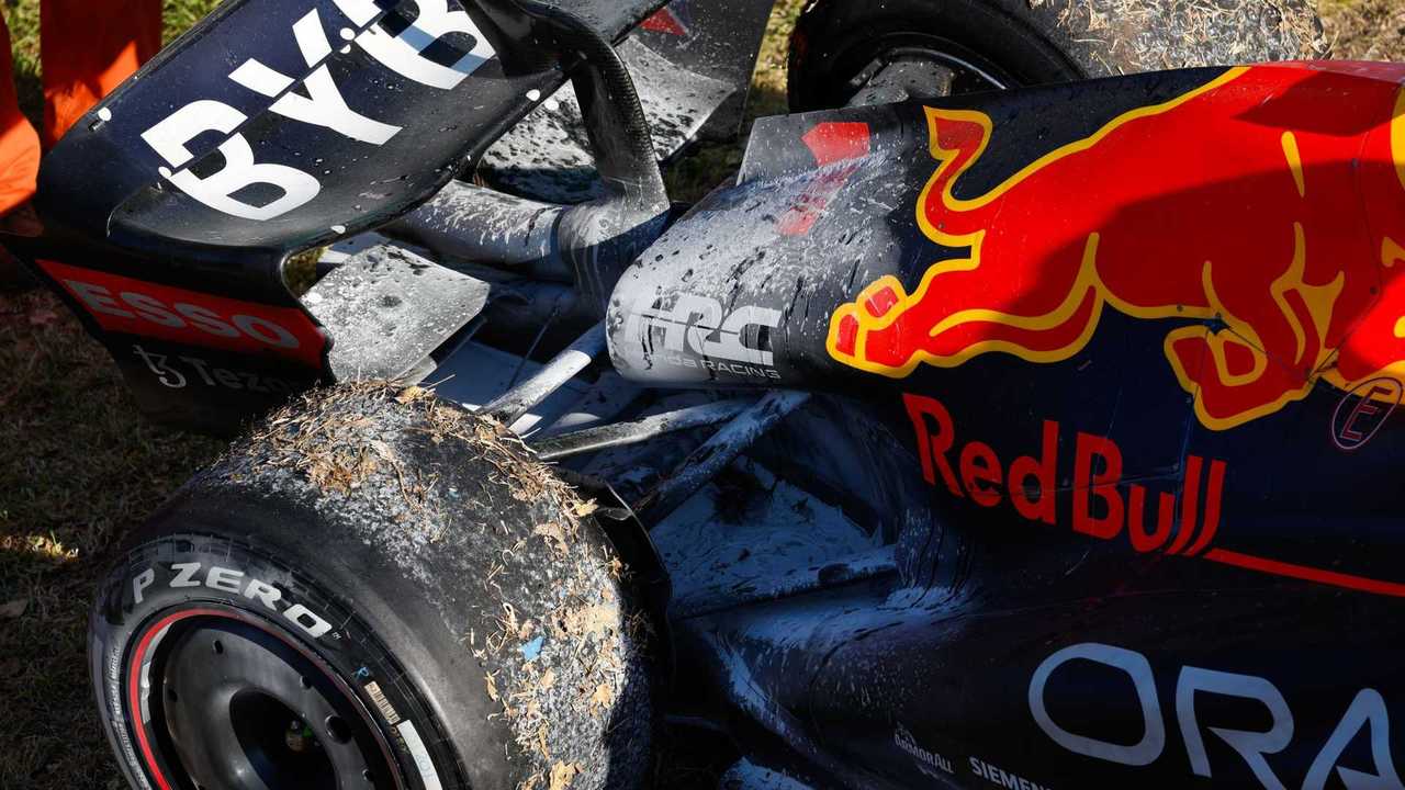 The car of Max Verstappen, Red Bull Racing RB18, with fire retardant after retirement and a fire