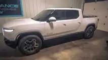 Glacier White Rivian R1T with tinted windows and taillights