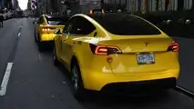 Gravity Tesla Model Y NYC yellow taxi rear three-quarter view