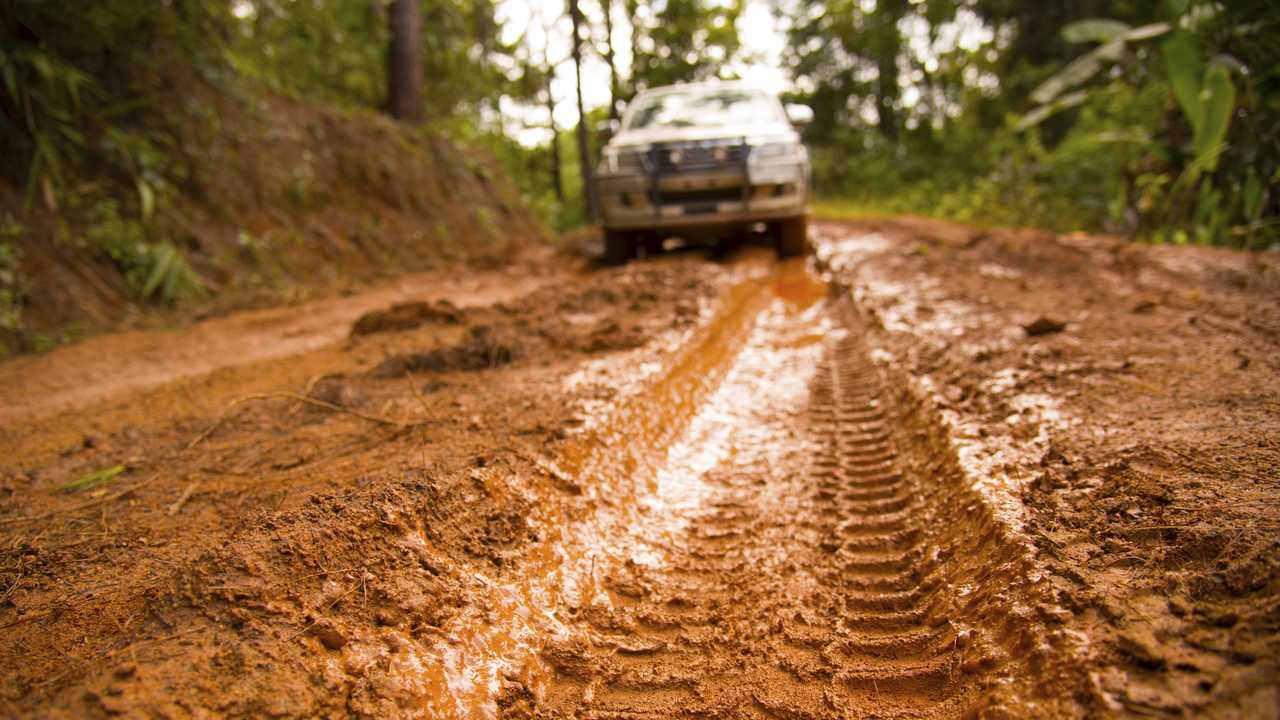 SUV adventure driving in nature on clay road