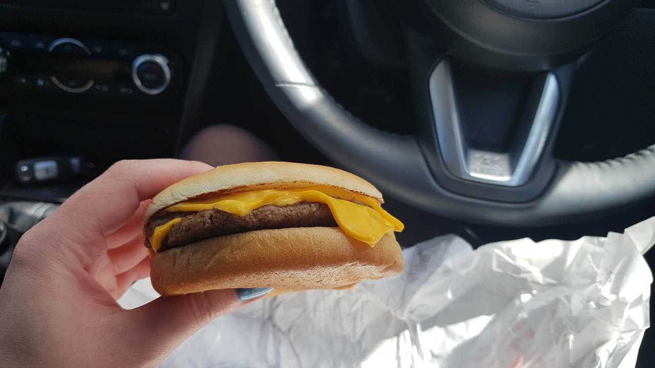 Driver eating burger in car