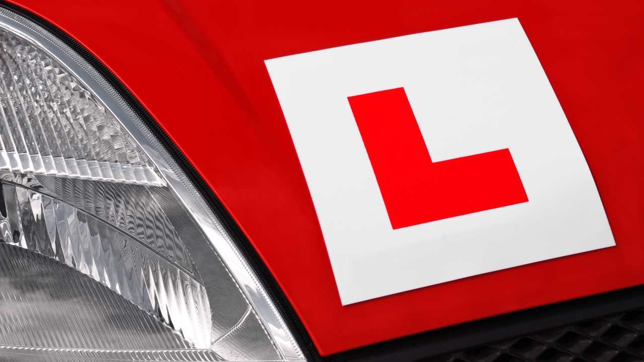L plate on red car in UK