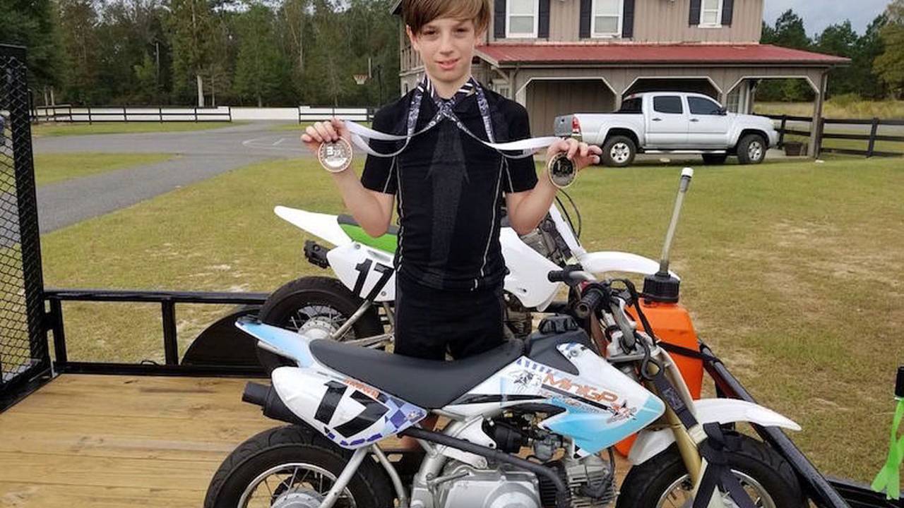 Keagan Brown showing off some of his medals