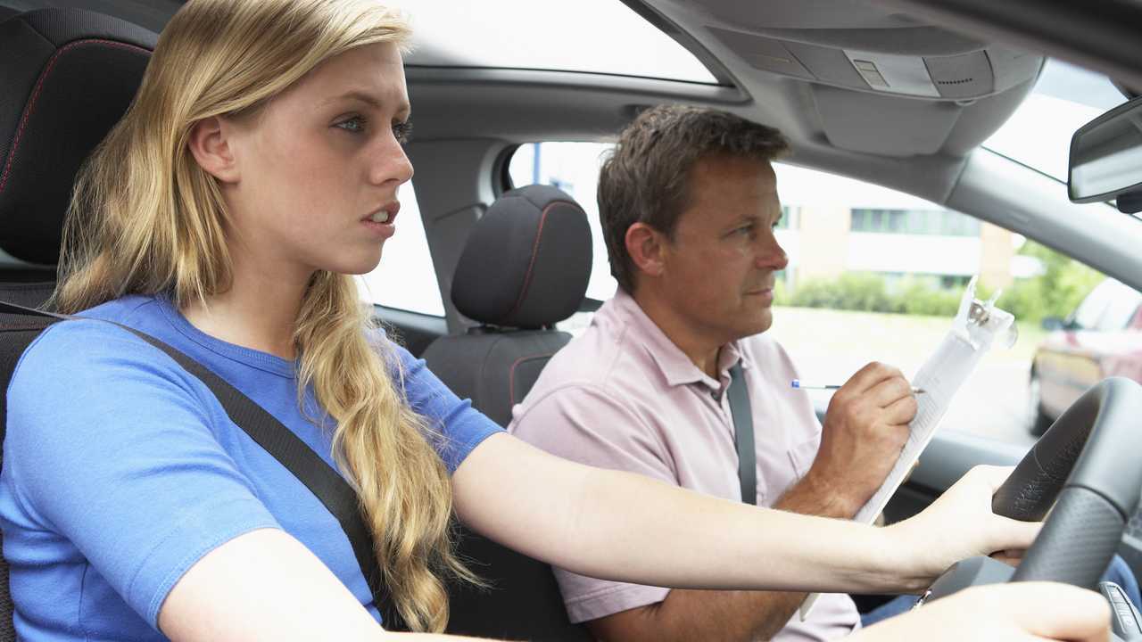 Teenage girl taking driving lesson
