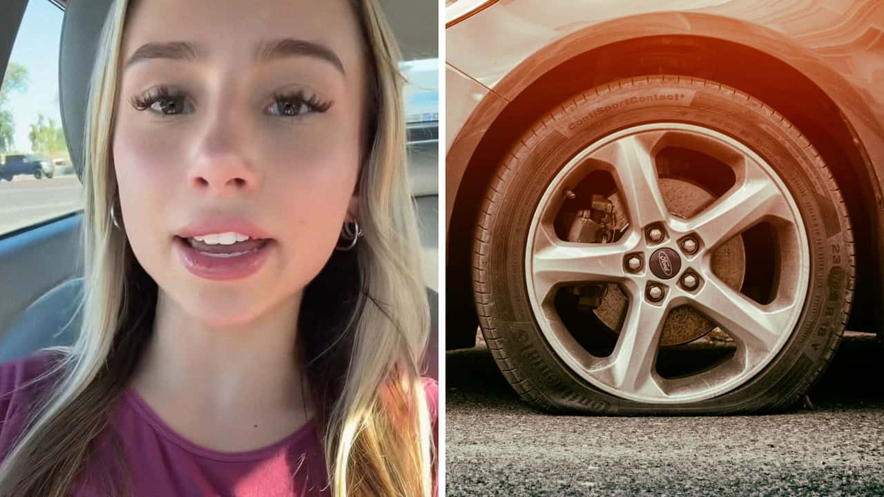 Woman tries to change her own tire 