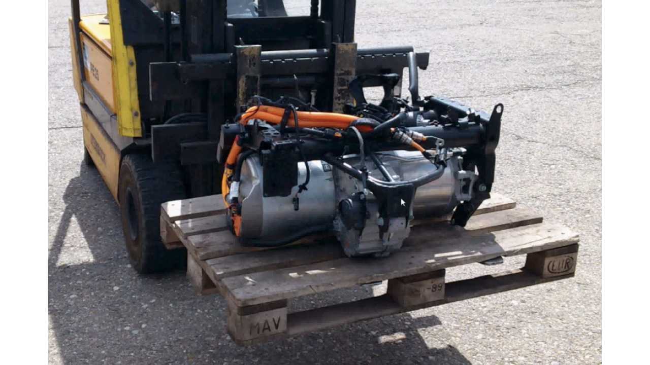 A significant amount of wiring is used to connect the Tesla motor/inverter (above) with the battery pack, but this is quickly changing.