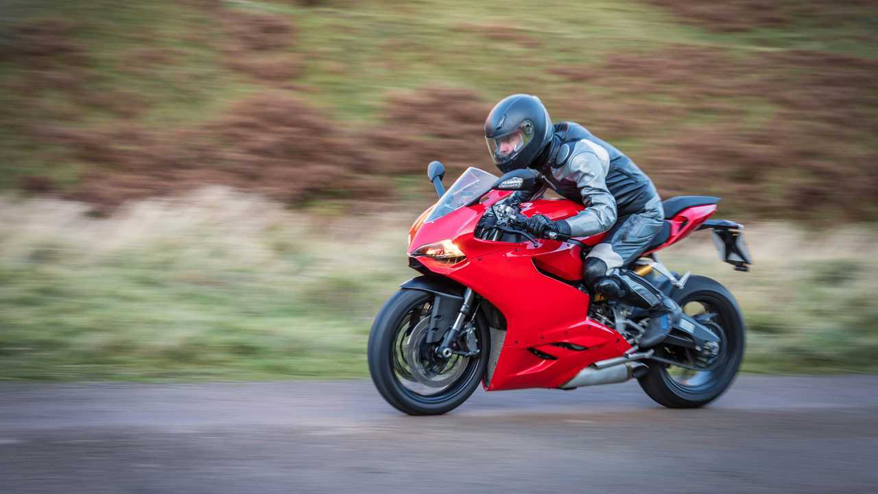 Sport motorcycle at speed on a country road in Upper Coquetdale Northumberland
