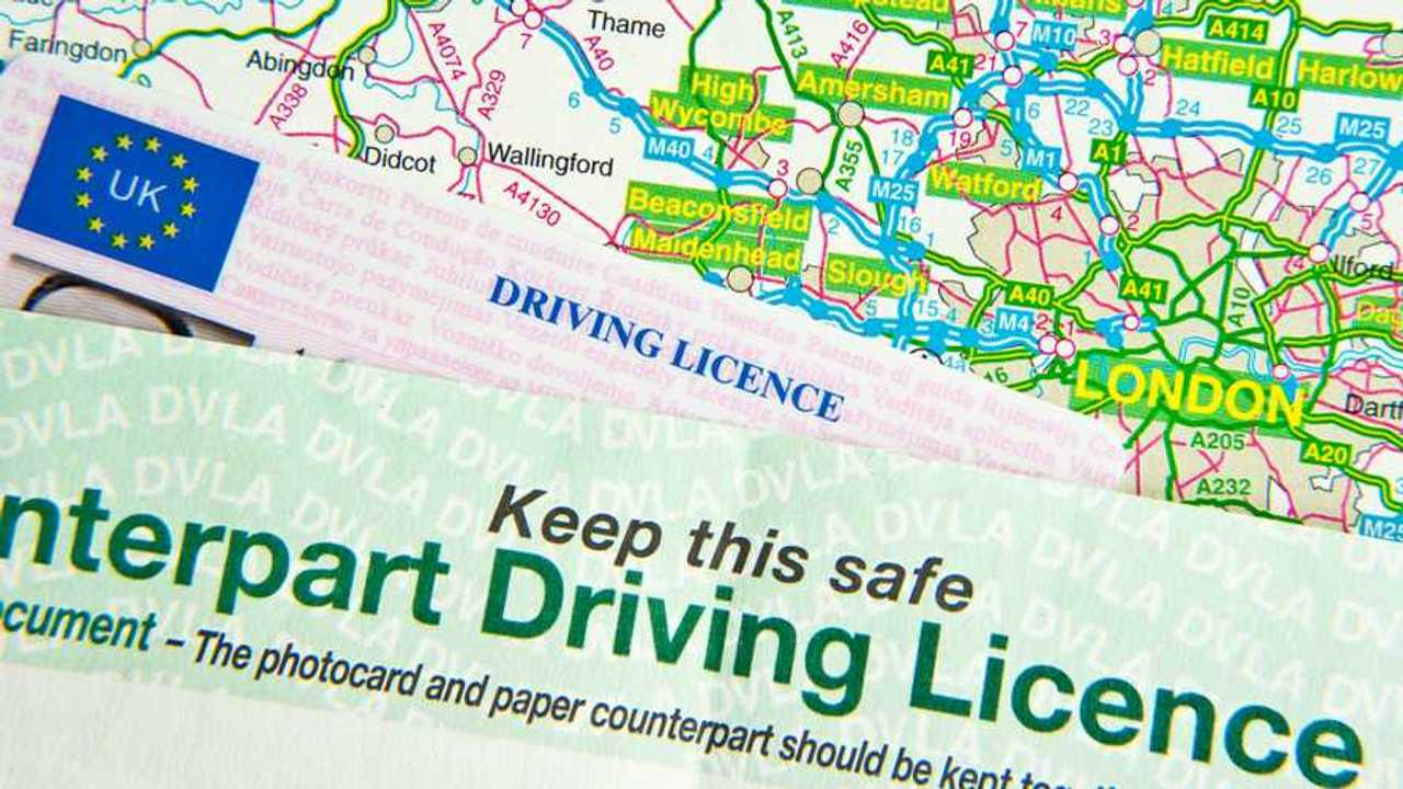 UK driving license on UK road map around London