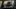 Thief wearing balaclava looking through car window