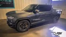 El Cap Granite Rivian R1T with tinted windows and front charging status LED bar