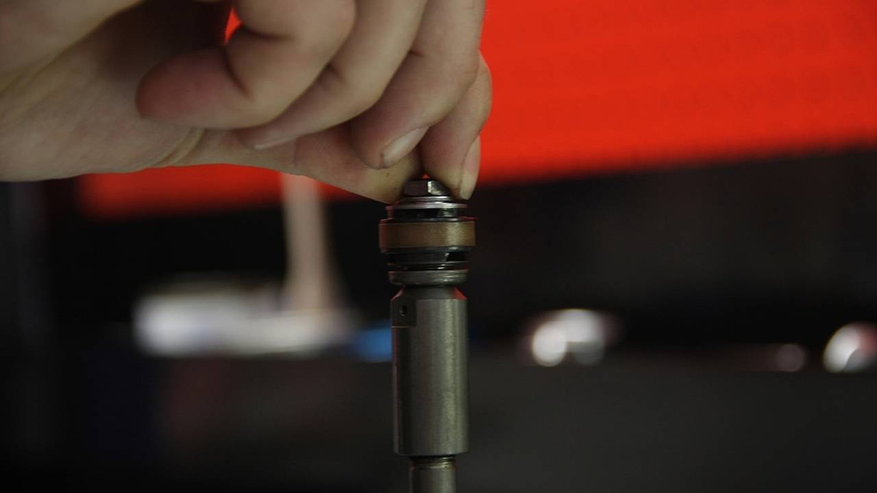 The rebound valve is reinstalled on the damper rod.