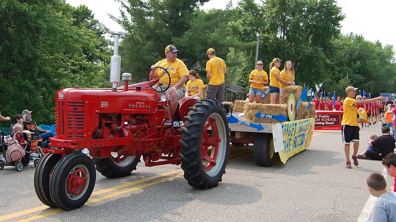 No parade is complete without tractors—this one is pulling the float for the Sauk Prairie Future Farmers of America (FFA).