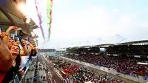 SLIDE SHOW   Fans look up as display smoke hangs in the air from the flypast