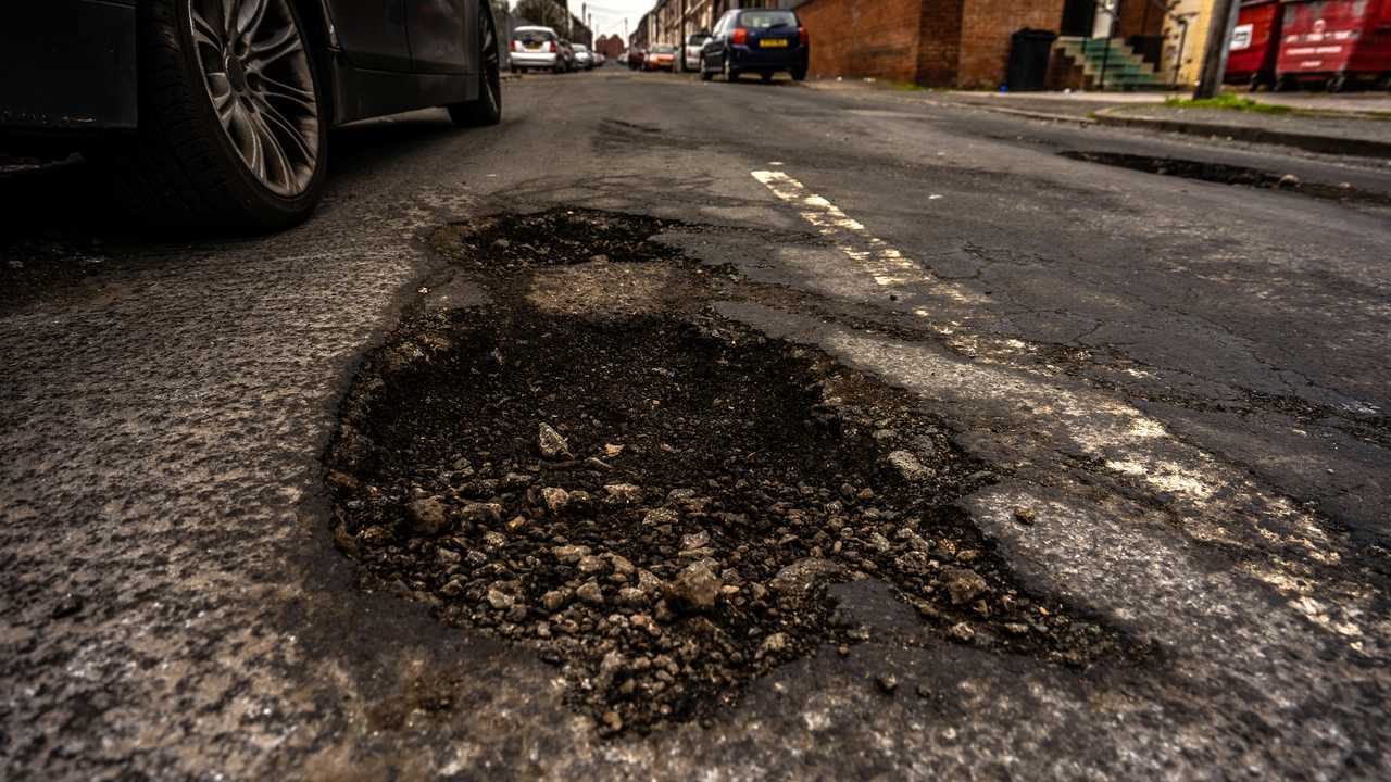 Deep pothole in road surface