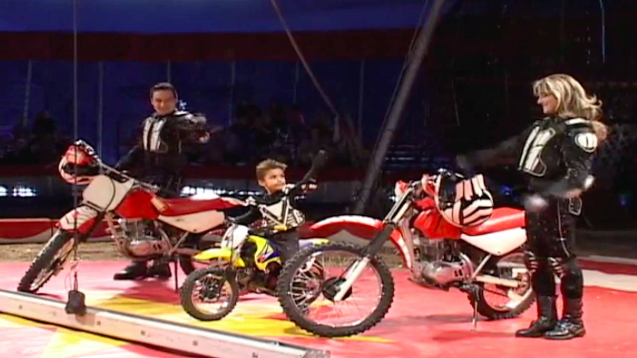 Maximus Garcia poses with his mom and dad who are also traveling stunt performers