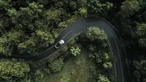 Aerial view of XPENG P5 driving on winding road