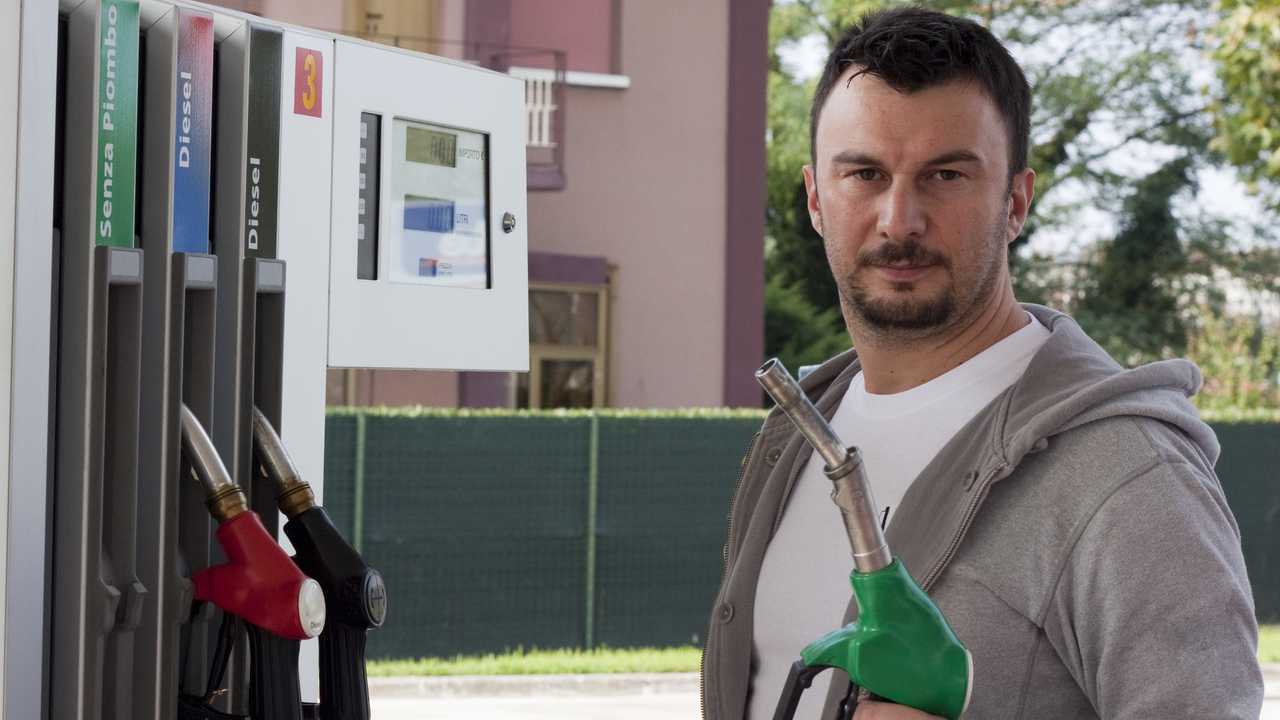 Man refuelling car at petrol station