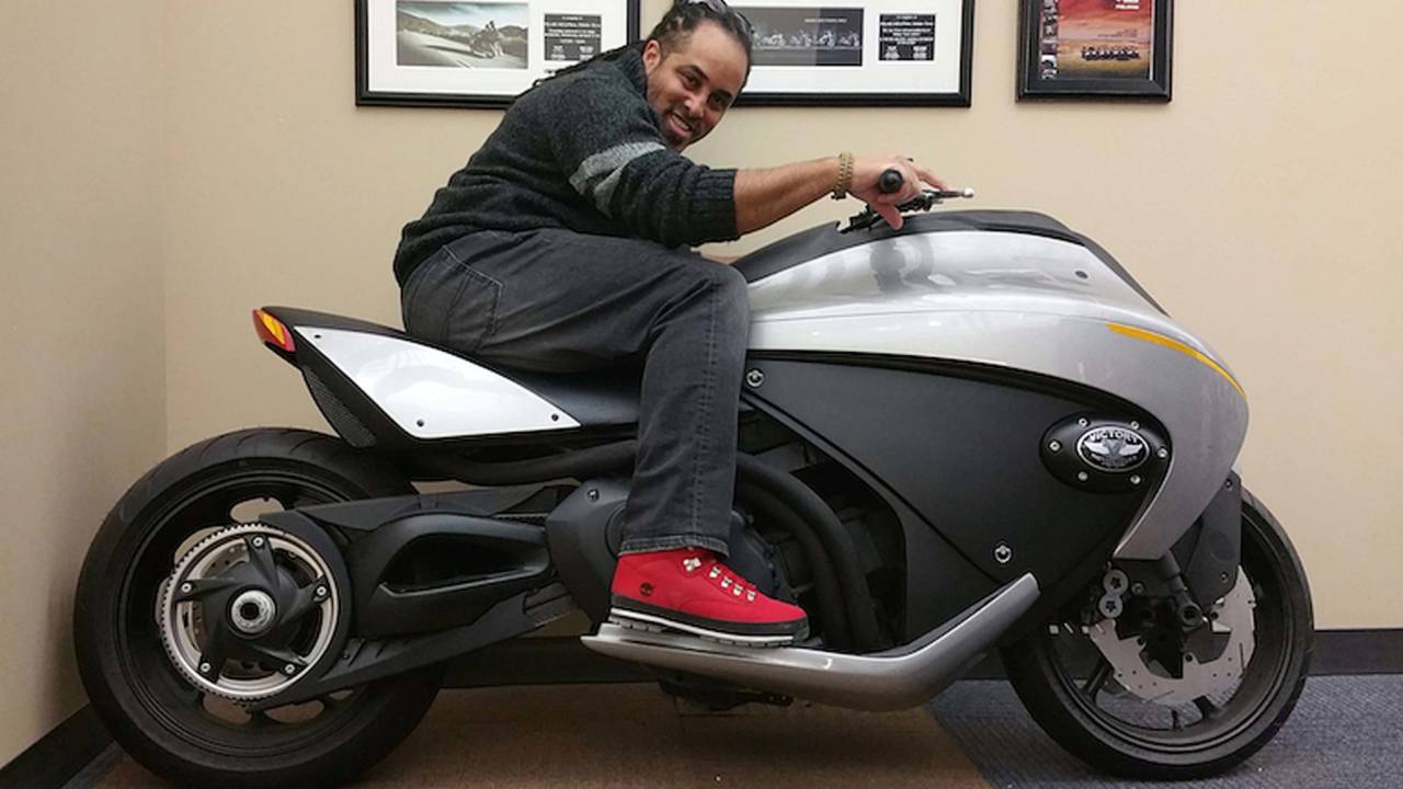 <em>Designer Tiger Bracy sits on the Vision 800 concept, which is now displayed in his office.</em>
