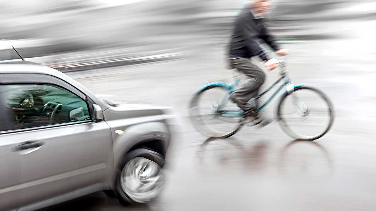 Dangerous traffic situation with cyclist and car