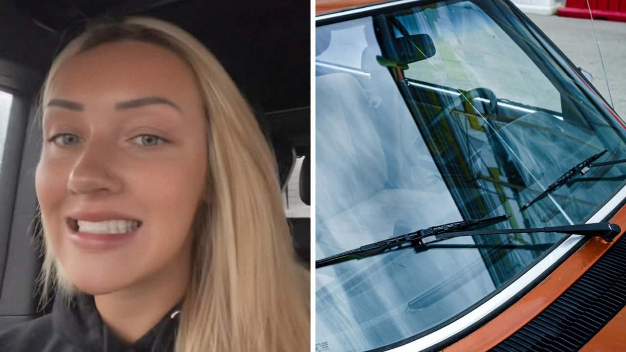 Woman pours windshield wiper