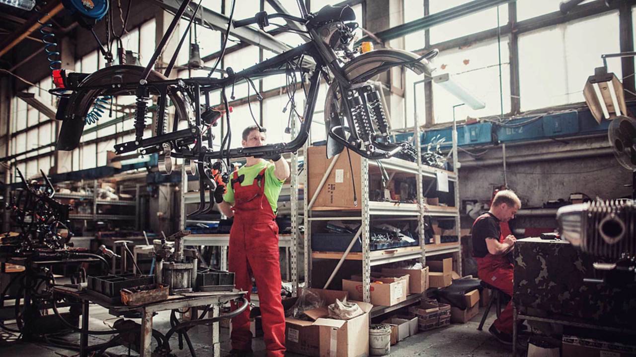 A Ural employee wrangles a frame into his work area.