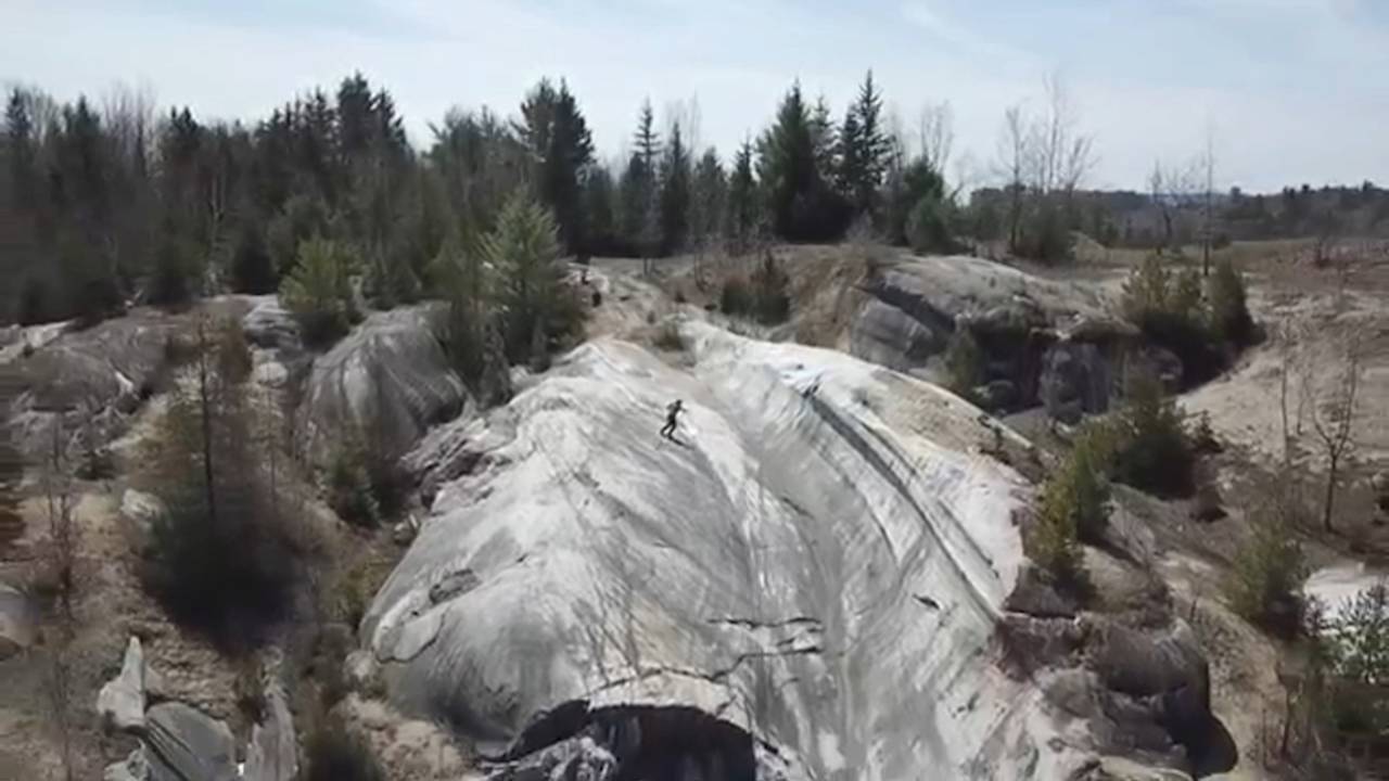 A drone shot of a halfpipe-esque section of rock