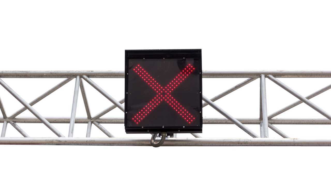 Traffic light over motorway shows red X