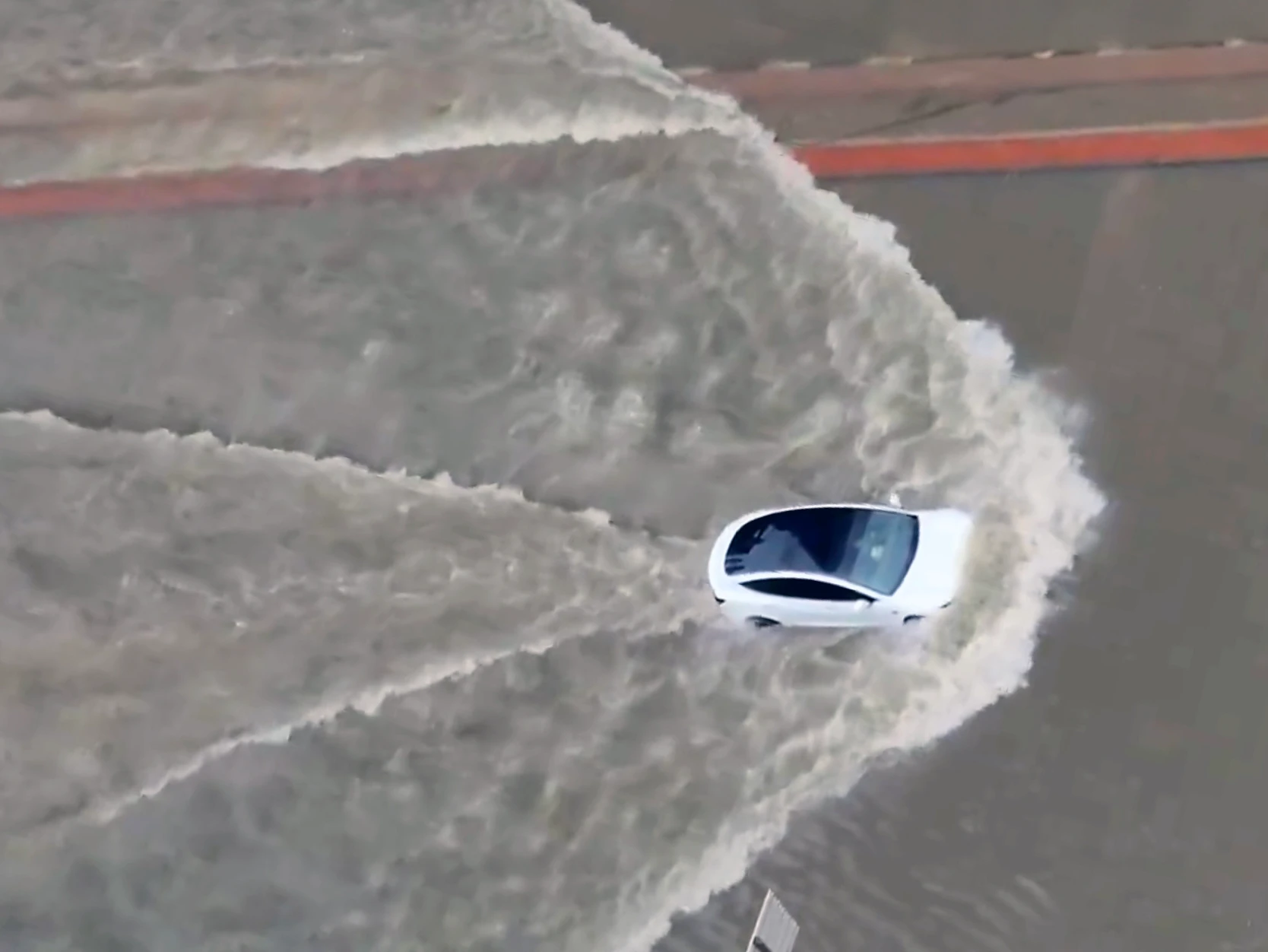 Watch A Tesla Model 3 And Porsche Taycan Drive Down Flooded Streets In Dubai