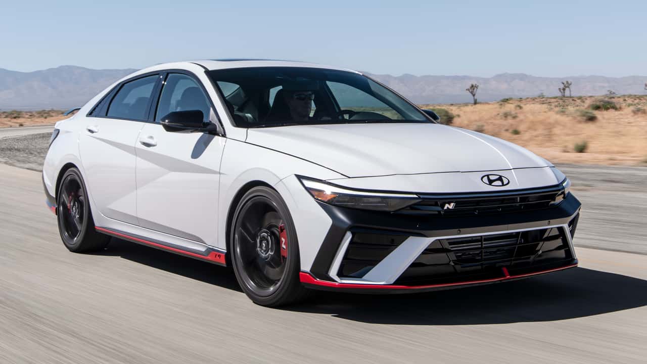2024 hyundai elantra n front three quarter driving on a road