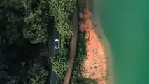Drone view of XPENG P5 driving on winding road