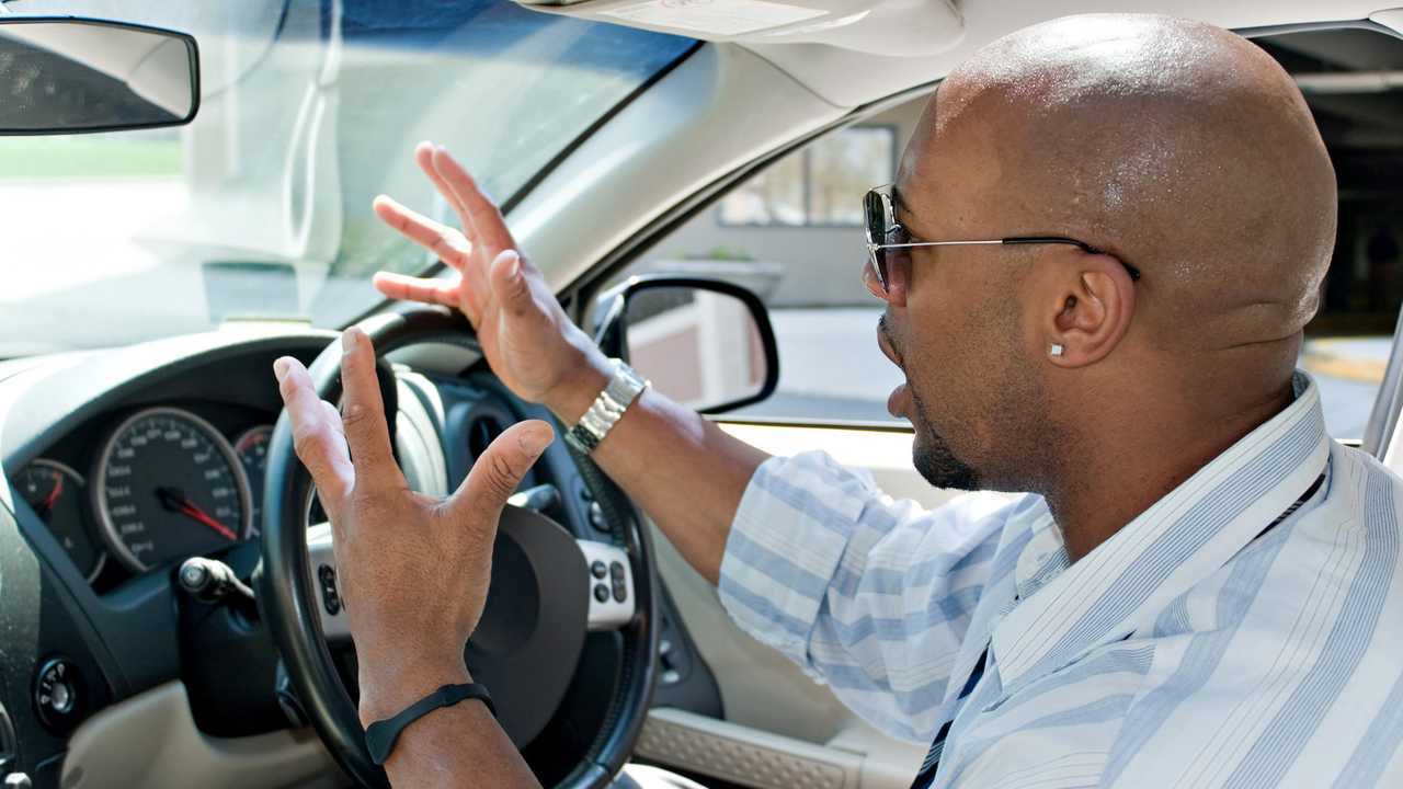 Driver expressing his road rage with hands in the air