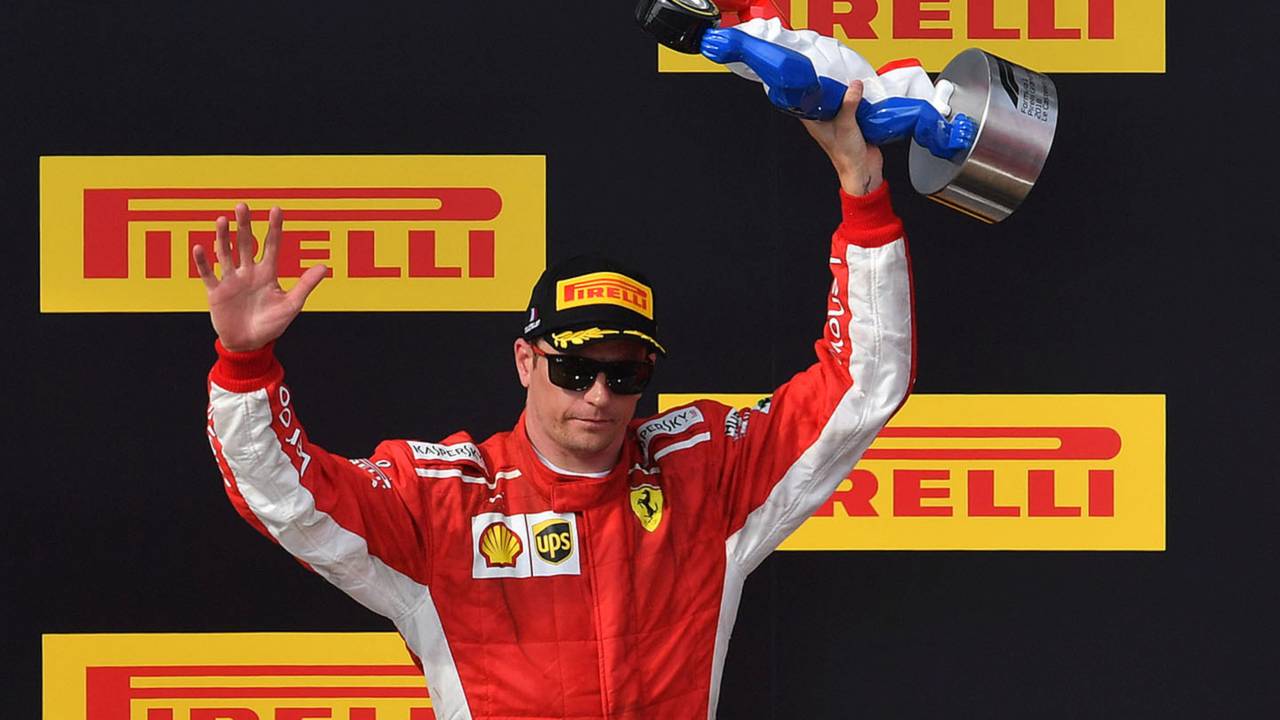 Kimi Raikkonen, Ferrari celebrates on the podium with the trophy