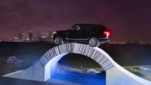 Range Rover driving over a paper bridge