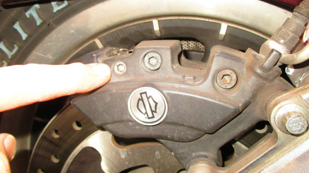 This pin is removed with an Allen wrench to release pads.