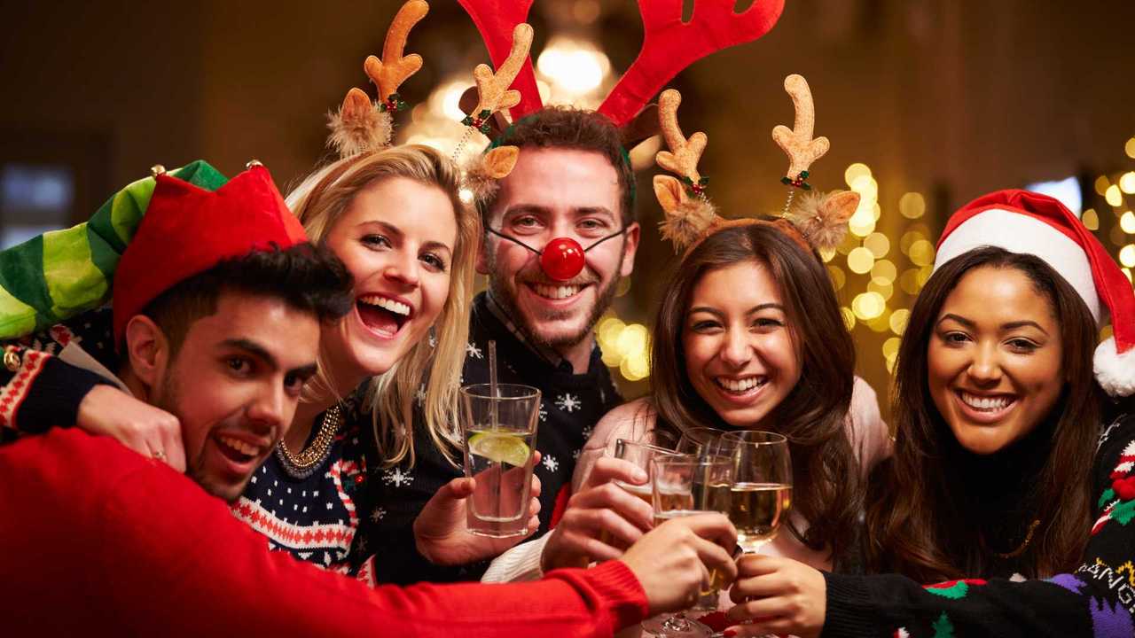 Group of friends enjoying Christmas drinks in pub