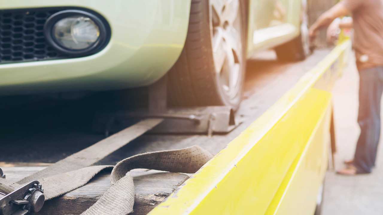 Recovery breakdown lorry with car being secured for transport