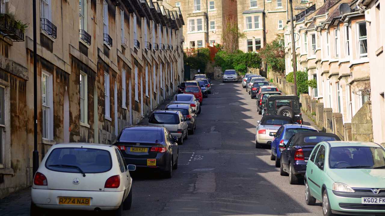 Car parking along the road beside resident houses in Bath UK