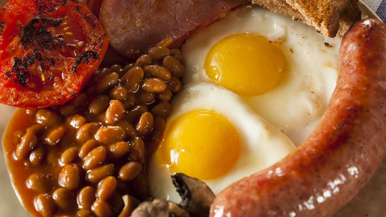 Traditional English breakfast with eggs bacon sausage and baked beans