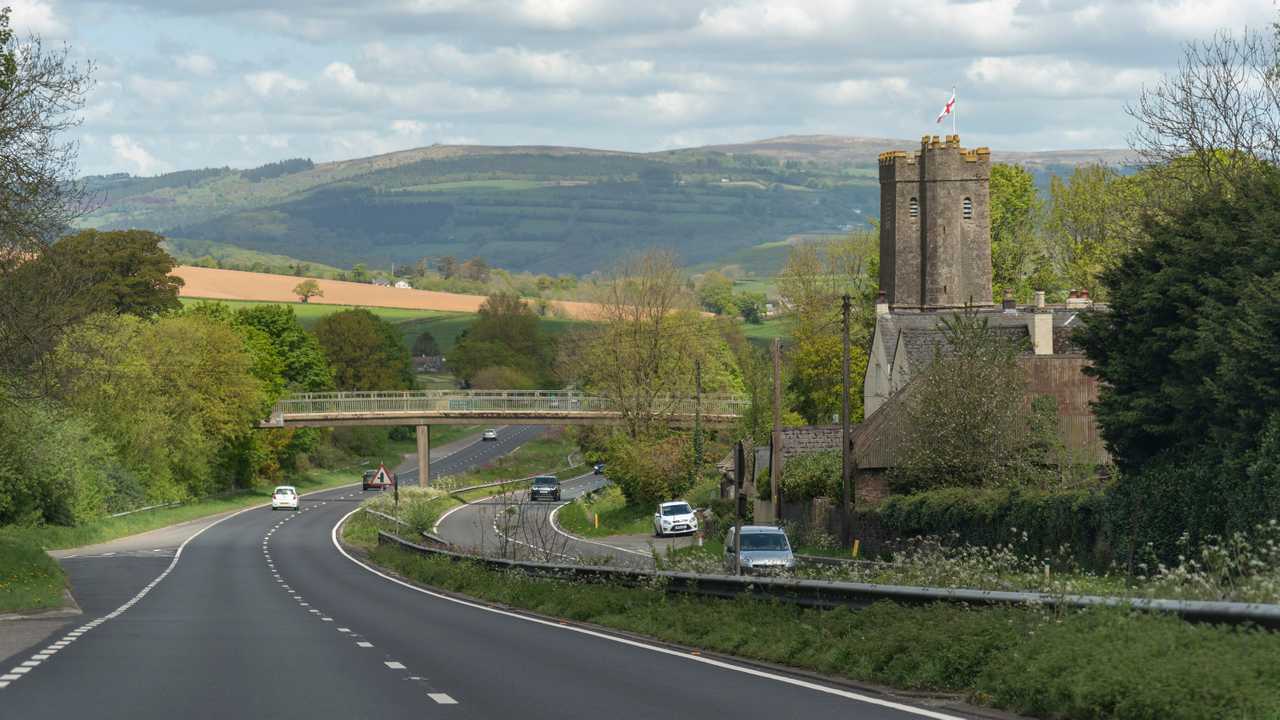 A38 Devon Expressway and St George the Marty church overlooked by the Dartmoor National Park at Dean Prior