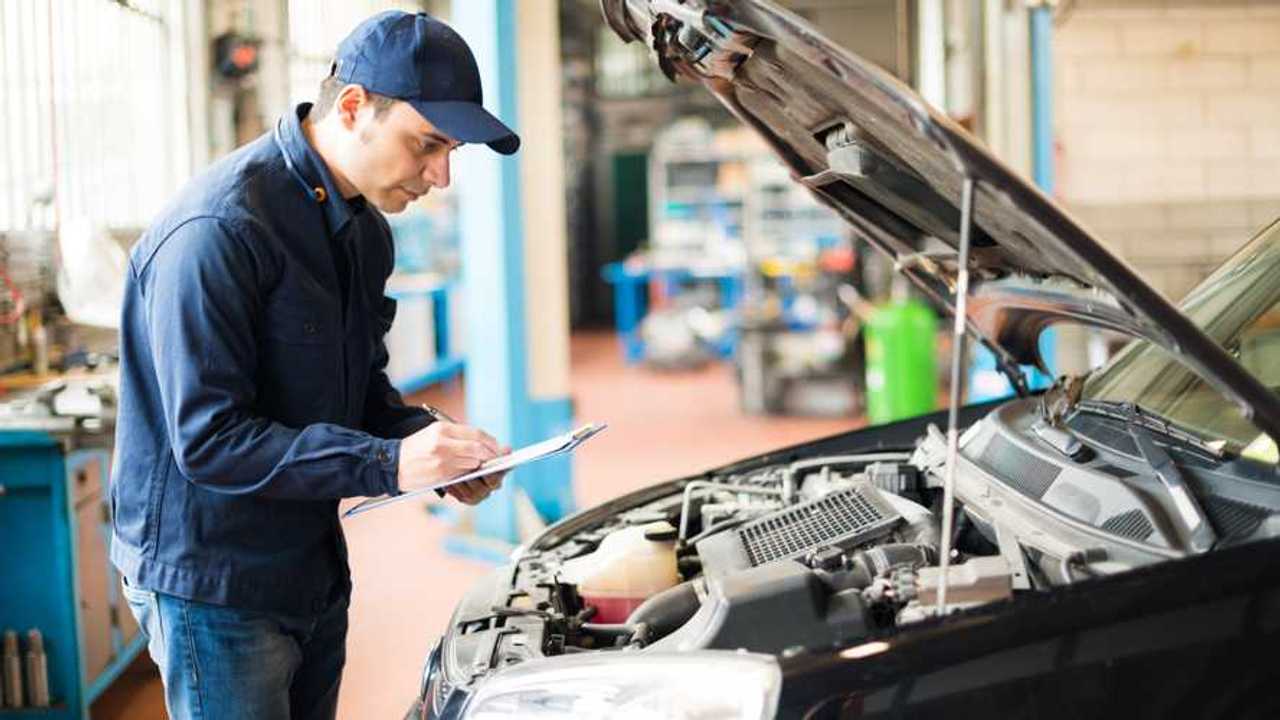 Mechanic performing MOT inspection