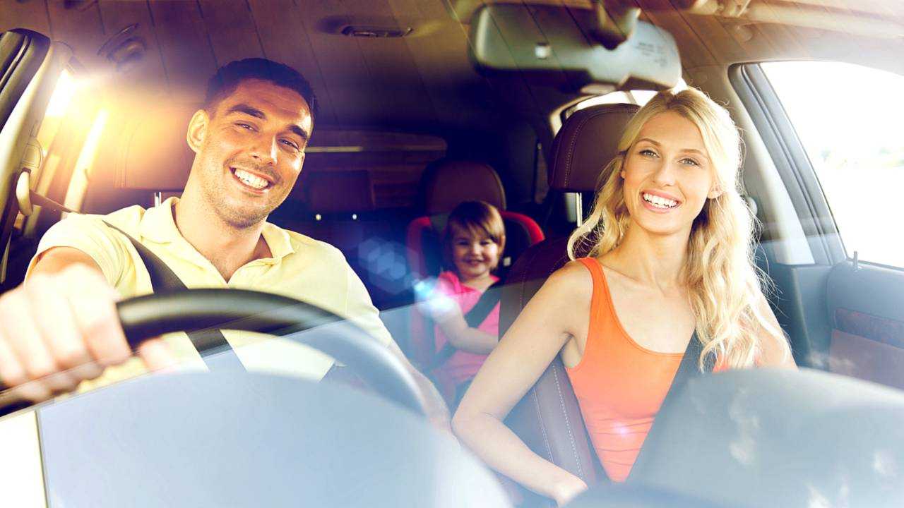 Happy family driving in car