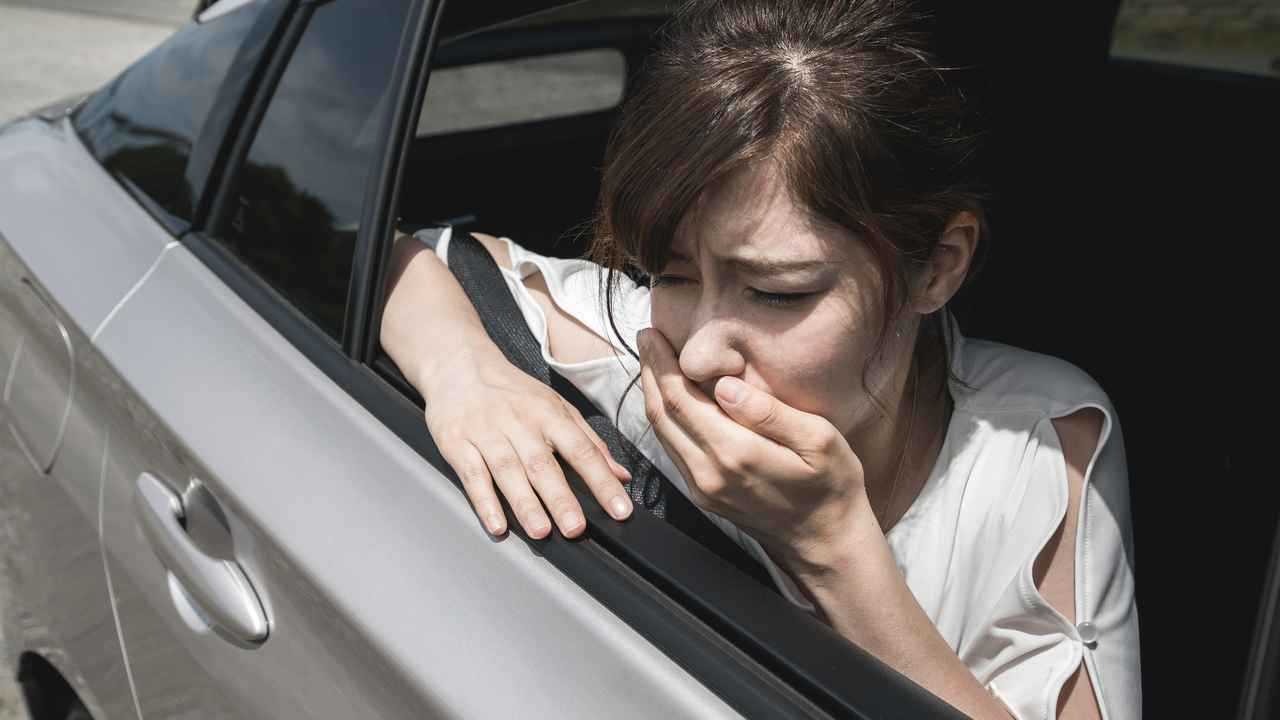 Young woman having car sickness