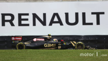 Pastor Maldonado, Lotus F1 E23 passe devant une publicité Renault