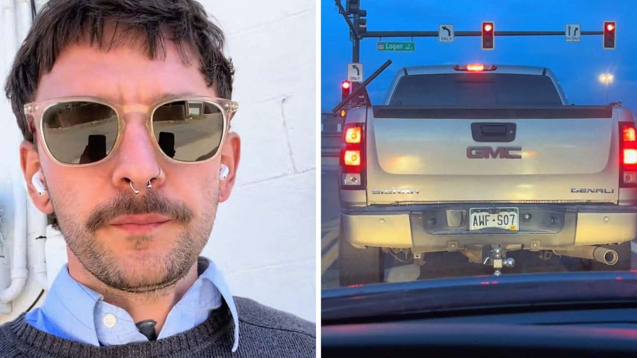 Man stops behind GMC Denali at stoplight.