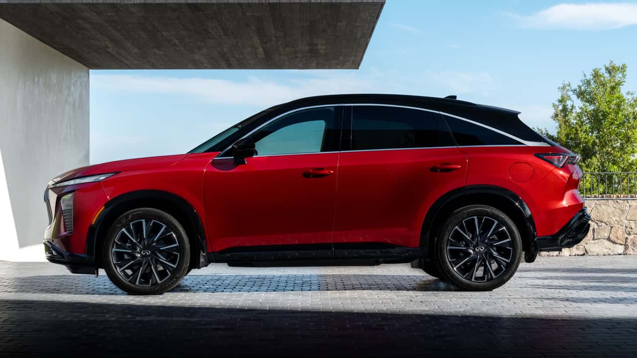 Rear exterior of the 2027 INFINITI QX65 showing fastback roofline and LED taillights