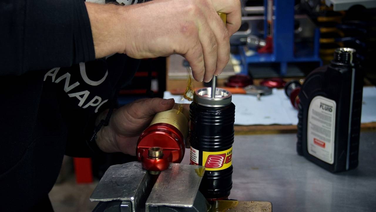 Matt intentionally overfills the reservoir before installing the piston, to help ensure as little air as possible will need to be purged. It's a messy step, but a necessary one.