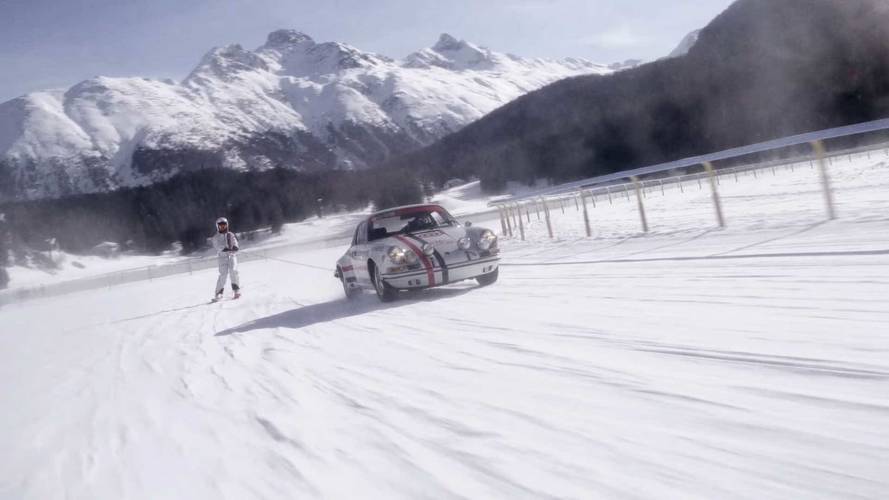 Porsche pulling skiers on frozen lake