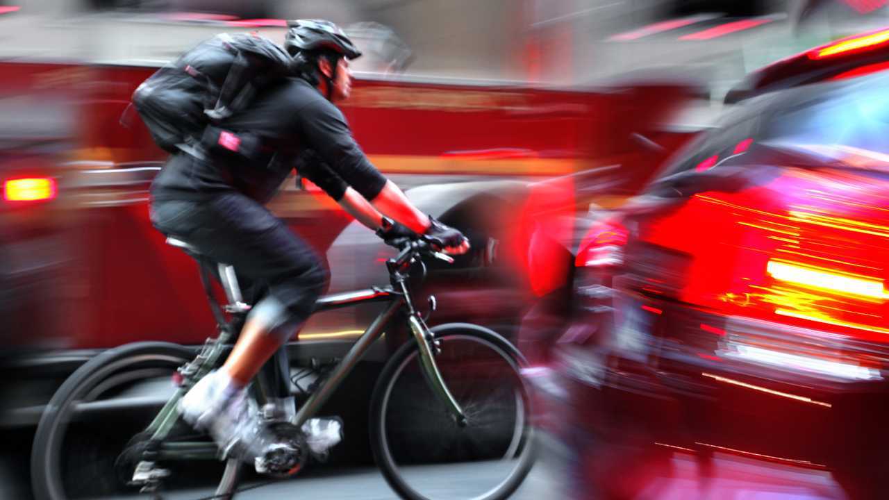 Cyclist in traffic on city road